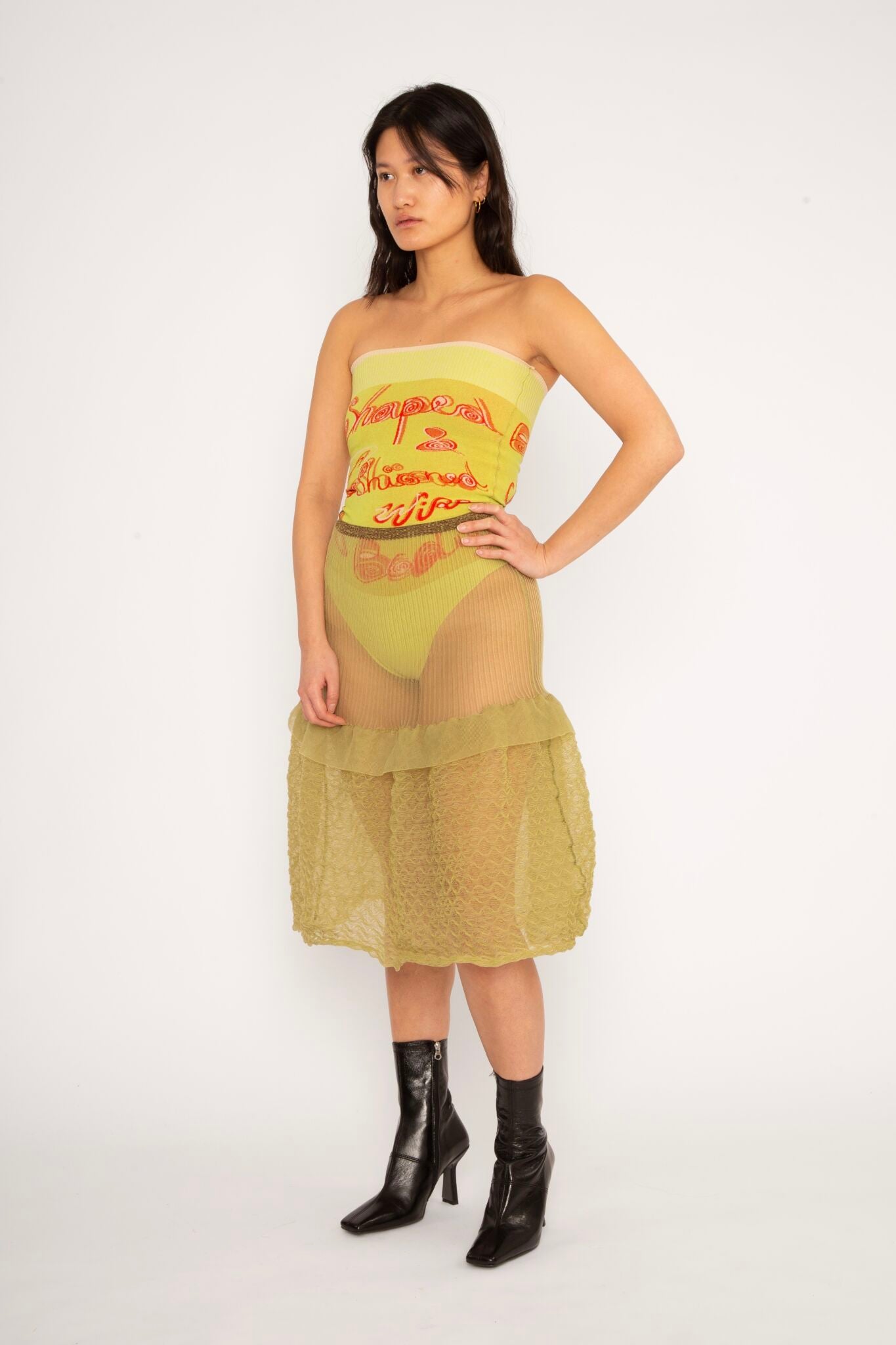 Bubble Midi Skirt in khaki is a transparent knitted trumpet skirt in a ribbed bubble texture. The skirt has a body fitted upper part and voluminous bottom. Detailed with ruffles and a melange rim with logo in the back. the textile is lightweight, delicate and very flexible, meaning the skirt adapts to body wearing it. The Bubble Midi Skirt is also available in black and comes in 2 different sizes.