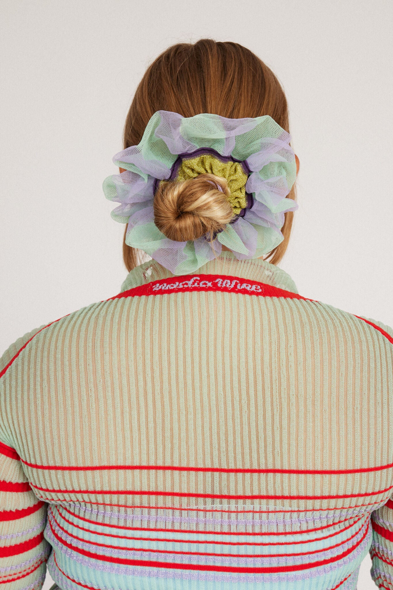 Petunia Scrunchie in mint green and lilac is a knitted scrunchie in bold stripes. Made of transparent and shimmery yarns.