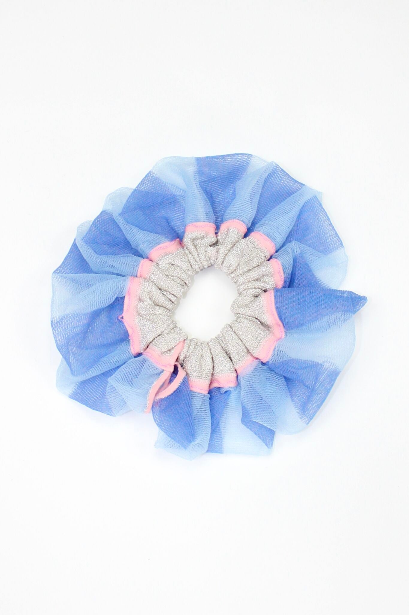 Petunia Scrunchie in powder blue and pink is a knitted scrunchie in bold stripes. Made of transparent and shimmery yarns.