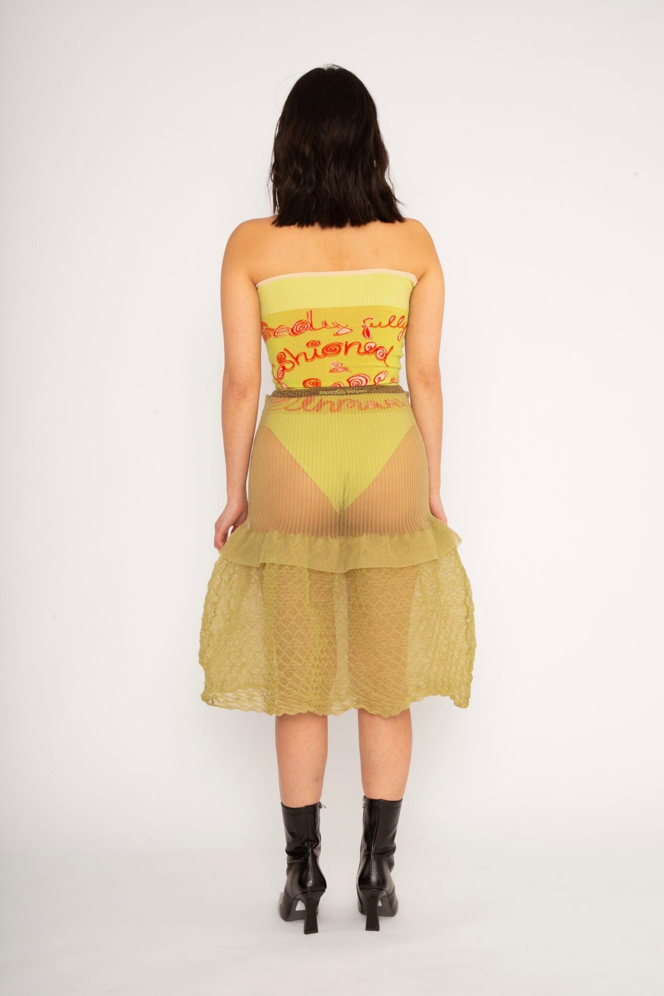 Bubble Midi Skirt in khaki is a transparent knitted trumpet skirt in a ribbed bubble texture. The skirt has a body fitted upper part and voluminous bottom. Detailed with ruffles and a melange rim with logo in the back. the textile is lightweight, delicate and very flexible, meaning the skirt adapts to body wearing it. The Bubble Midi Skirt is also available in black and comes in 2 different sizes.