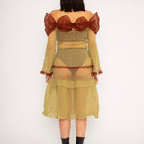 Bubble Bell Top in khaki and cherry red is a transparent knitted off-shoulder top in a ribbed bubble texture with ruffles and bell sleeves. The top has a close fit body with long sleeves and a voluminous adjustable neckline detailed with a melange rim with a logo in the back. The textile is lightweight, delicate and very flexible, meaning the dress adapts to body wearing it. The Bubble Bell Top is also available in teal and comes in 2 different sizes.