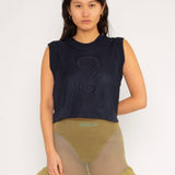 Spiral Top in navy is a knitted cropped crew neck top with spiral artwork. The textile has a shine to it and is lightweight with a smooth and soft feel against the body. The top has a slightly loose fit and is detailed with ribbed rims. The Spiral Top is available in 3 different sizes.