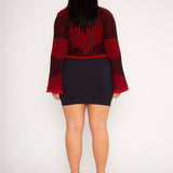Wavy Wool Cardigan in red and black is a knitted cropped mohair cardigan with flared sleeves and all-over wavy stripes. Detailed with a heart in the back. The cardigan has a ribbed V-shaped neckline, a three-button closure and is cut for a slightly loose fit. The textile is fluffy, non-itchy and comfortable against the skin. The Wavy Wool Cardigan is also available in turquoise and comes in 3 different sizes.