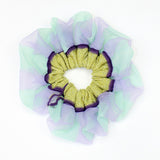 Petunia Scrunchie in mint green and lilac is a knitted scrunchie in bold stripes. Made of transparent and shimmery yarns.