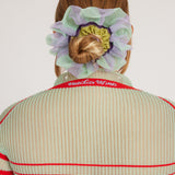 Petunia Scrunchie in mint green and lilac is a knitted scrunchie in bold stripes. Made of transparent and shimmery yarns.