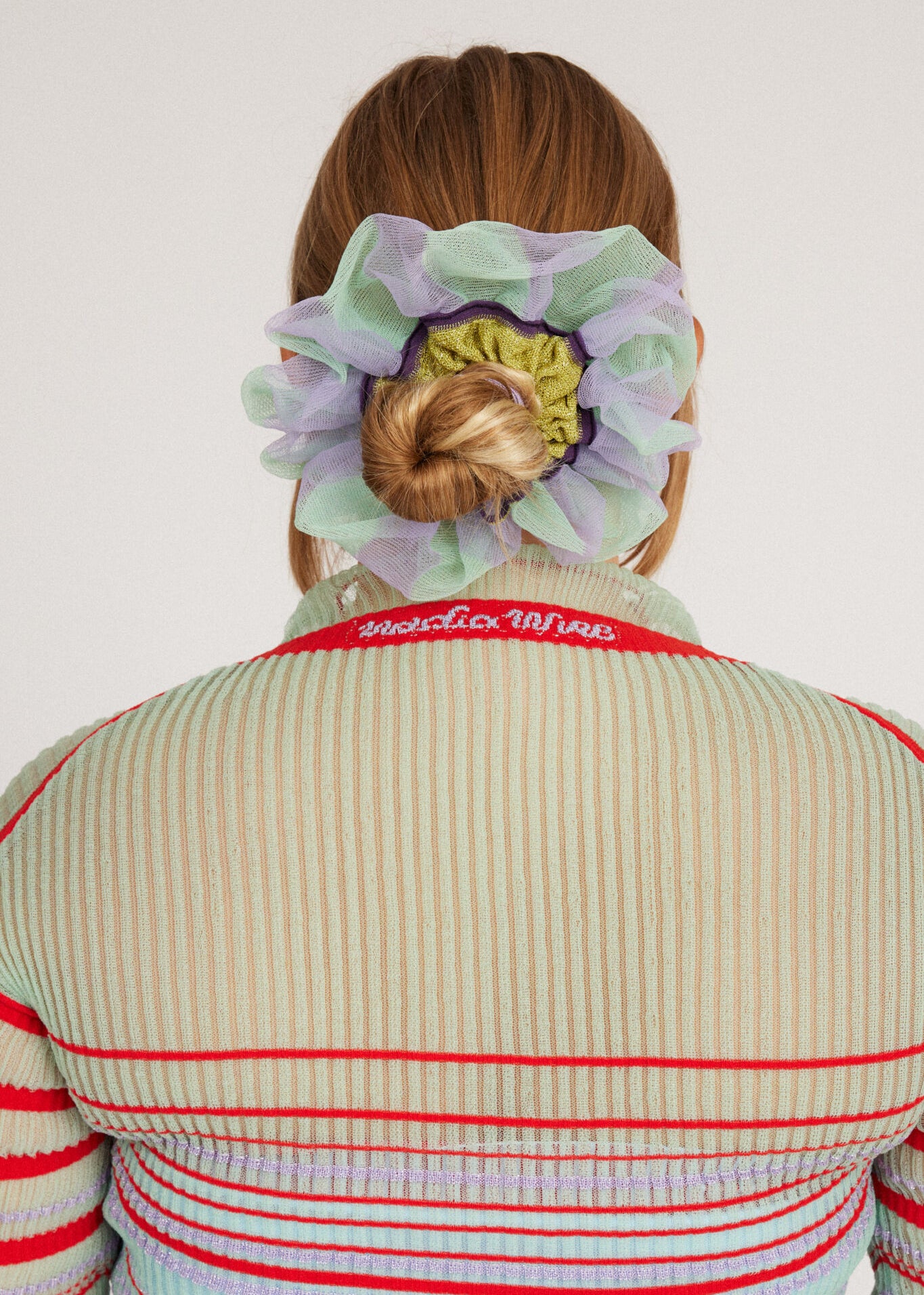 Petunia Scrunchie in mint green and lilac is a knitted scrunchie in bold stripes. Made of transparent and shimmery yarns.