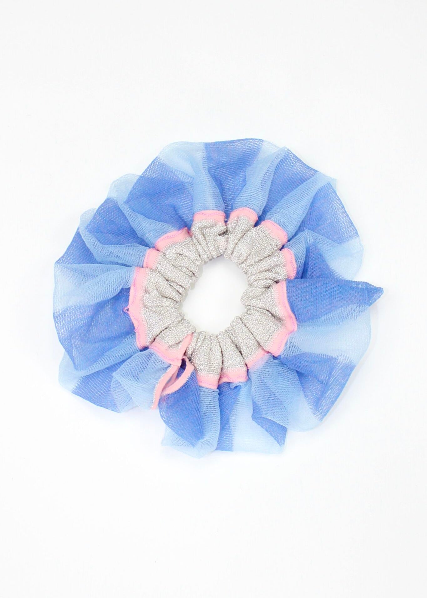 Petunia Scrunchie in powder blue and pink is a knitted scrunchie in bold stripes. Made of transparent and shimmery yarns.