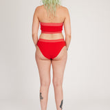 Spring Bloomer Top in red and pink is a knitted sporty tube top with logo and ribbed edges. Knitted in a body fitted, yet flexible material that adapts to the body. Can be mixed and matched with Spring Bloomer Panty and be used as swimwear.