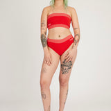Spring Bloomer Panty in red and pink are a knitted pair of high-waist pantys with logo and ribbed edges. Knitted in a body fitted, yet flexible material that adapts to the body. Can be mixed and matched with Spring Bloomer Top and be used as swimwear.