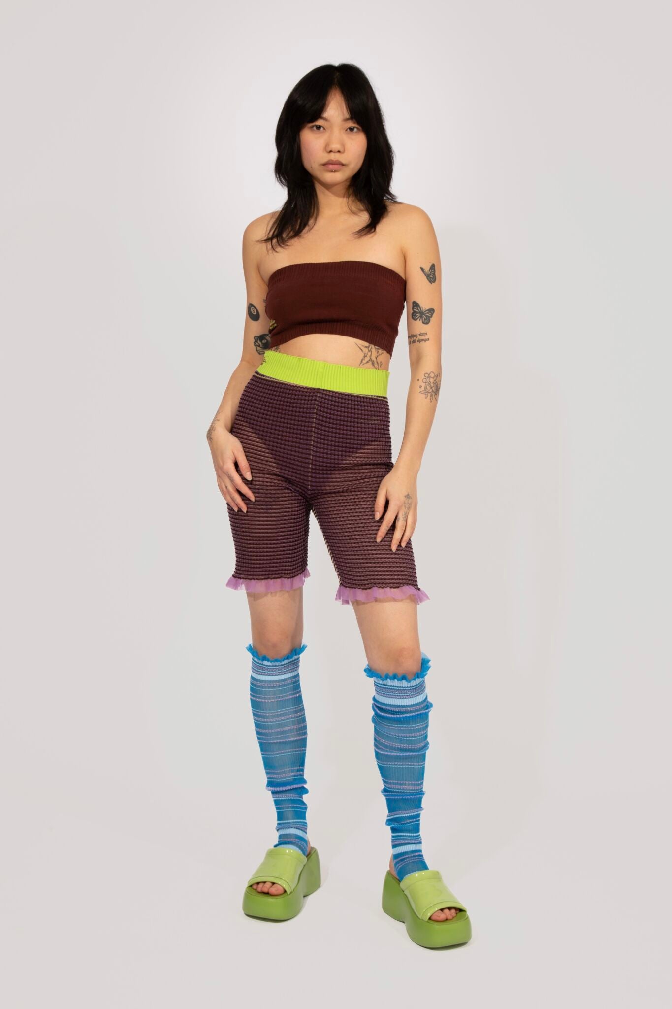 Striped knitted Frills in blue, transparent frills in gradient stripes and Stripe knitted Shorts in brown and lime, transparent all over stripes