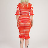 Sweet Secret Dress in coral red is a transparent knitted short sleeved high neck dress in gradient stripes with shimmery metallized yarn. The textile is lightweight, delicate and very flexible. The dress has a body fitted silhouette that adapts to the body. Detailed with frills and a logo in the back of neck.