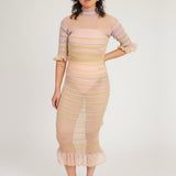 Sweet Secret Dress in peach blonde is a transparent knitted short sleeved high neck dress in gradient stripes with shimmery metallized yarn. The textile is lightweight, delicate and very flexible. The dress has a body fitted silhouette that adapts to the body. Detailed with frills and a logo in the back of neck.