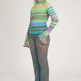 Sweet Secret Jumper in green and turquoise is a knitted transparent high neck jumper in all over bold stripes detailed with shimmery metallized yarn. The textile is lightweight, delicate and very flexible. The jumper has a body fitted silhouette that adapts to the body. Detailed with frills and a logo in the back of the neck.