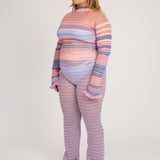 Sweet Secret Jumper in pink and powder blue is a knitted transparent high neck jumper in all over bold stripes detailed with shimmery metallized yarn. The textile is lightweight, delicate and very flexible. The jumper has a body fitted silhouette that adapts to the body. Detailed with frills and a logo in the back of the neck.