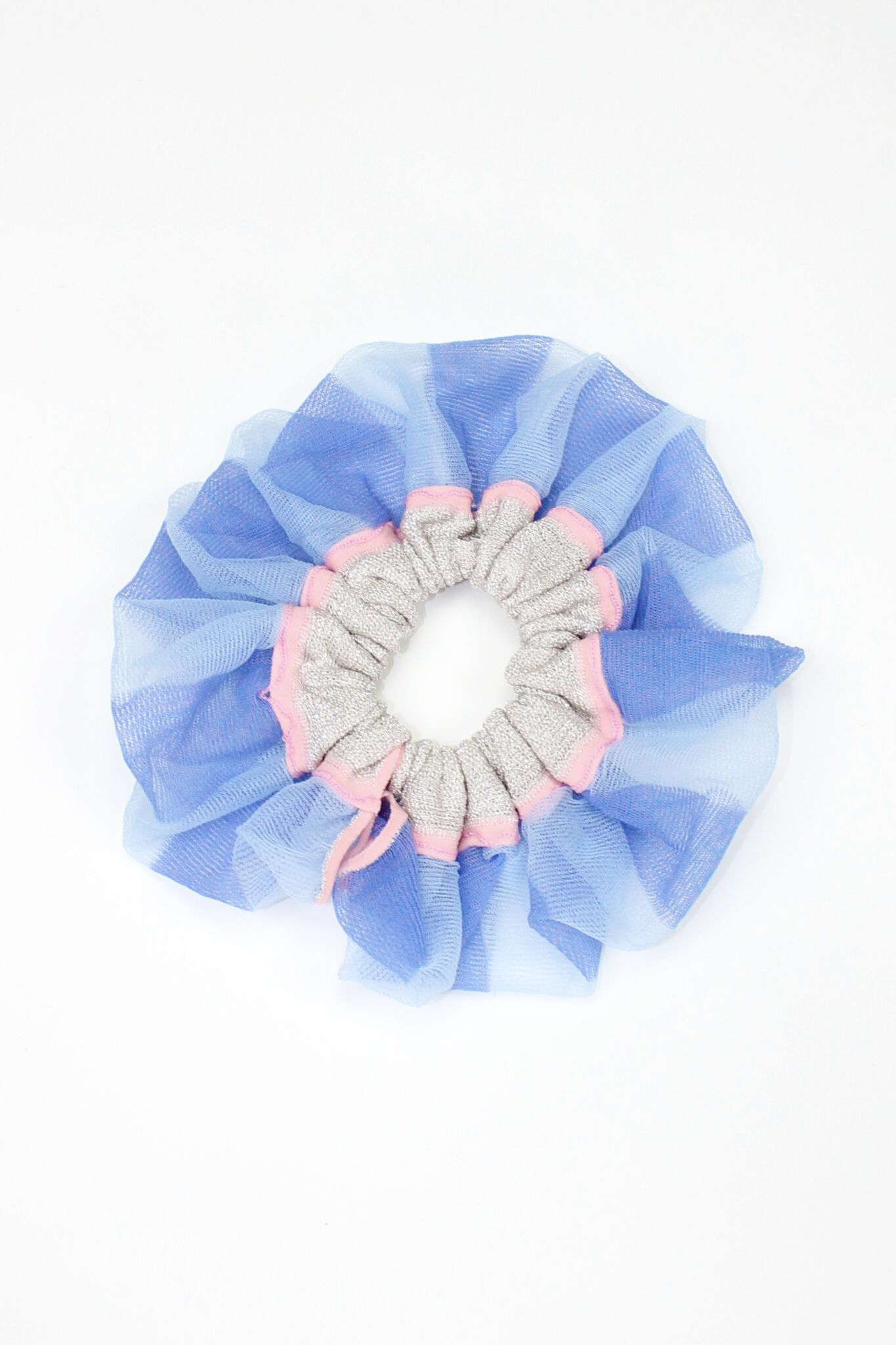 Petunia Scrunchie in powder blue and pink is a knitted scrunchie in bold stripes. Made of transparent and shimmery yarns.
