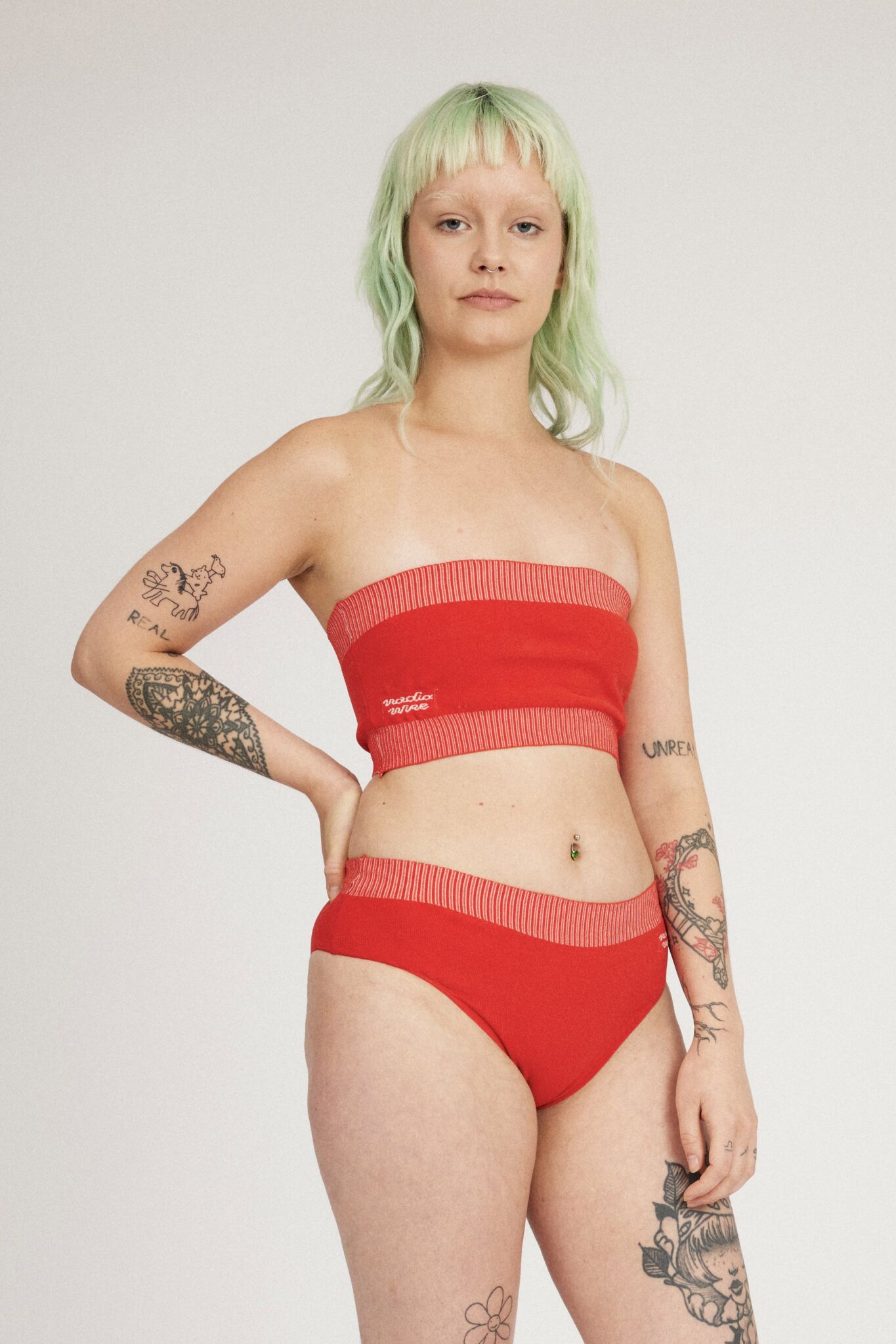 Spring Bloomer Top in red and pink is a knitted sporty tube top with logo and ribbed edges. Knitted in a body fitted, yet flexible material that adapts to the body. Can be mixed and matched with Spring Bloomer Panty and be used as swimwear.