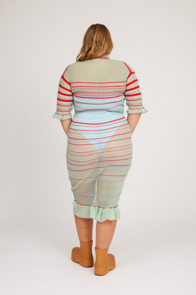 Sweet Secret Dress in mint green is a transparent knitted short sleeved high neck dress in gradient stripes with shimmery metallized yarn. The textile is lightweight, delicate and very flexible. The dress has a body fitted silhouette that adapts to the body.