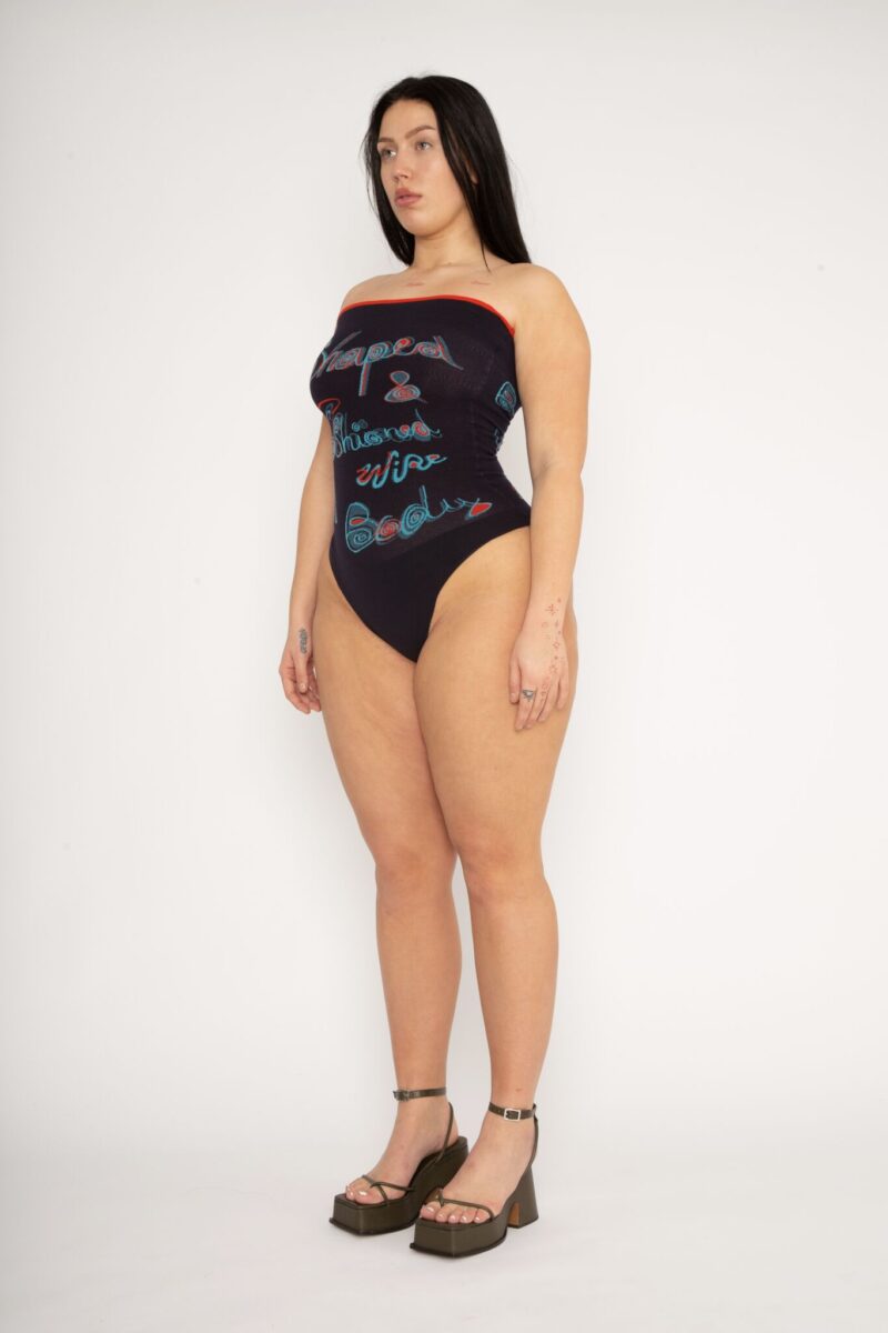 Fashioned Bodysuit in navy and turquoise is a jacquard knitted strapless body with 3D statement artwork in bold colours. Knitted in a fitted, yet very flexible material that adapts to the body and has a slight shaping effect. Detailed with a ribbed upper rim to keep it in place. The Fashioned Bodysuit is a tribute to our core values and production methods, with the text in the front stating ”Shaped & fashioned Wire body” and the back ”Body fully fashioned & shaped in Denmark”. Fully fashioning is a waste minimizing technique used when knitting all our garments. Available in 3 different colours and sizes.