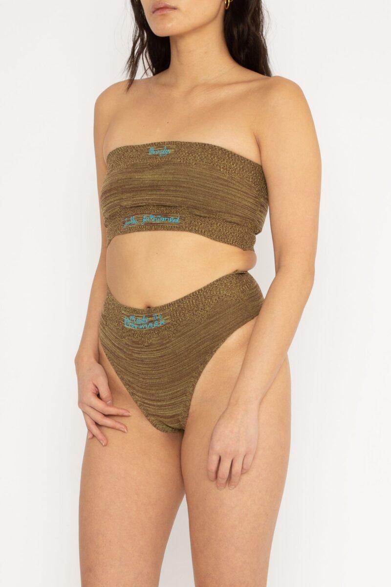 Fashioned Body Top in brown and yellow is a knitted tube top in melange with logo, ribbed edges and statement artwork in bold colours. The textile is body fitted, yet very flexible – therefore, the tube top adapts to the body. It can be mixed and matched with Fashioned Body Panty and be used as both swimwear and everyday bodywear. The Fashioned Body Top is a tribute to our core values and production methods, with the text in the front stating ”Body fully fashioned”. Fully fashioning is a waste minimizing technique used when knitting all our garments. Available in 3 different colours and sizes.