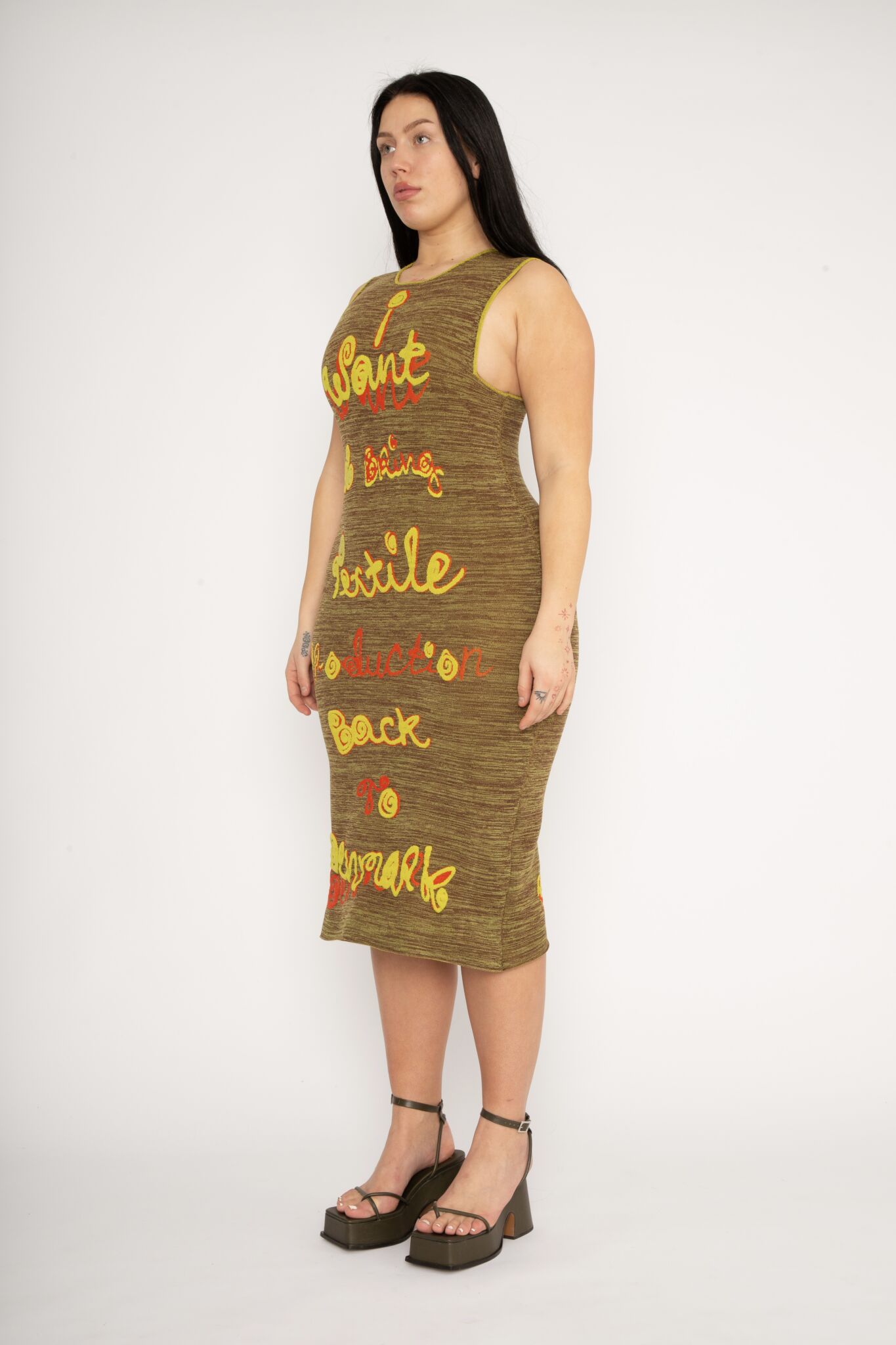 My Mission Dress in brown and yellow is a body fitted knitted jacquard dress in melange decorated with 3D statement artwork in bold colours. The dress is cut for a slim fit and has a slight shaping effect. A zipper has been added to make it easier to slide into. The merino wool makes the textile soft, and the nylon very flexible, meaning the dress adapts to the body wearing it. The My Mission Dress is a tribute to our core values and production methods, with the text in the front stating ”I want to bring textile production back to Denmark” and the back ”I simply don’t believe in mass production”. Available in 3 different colours and sizes.