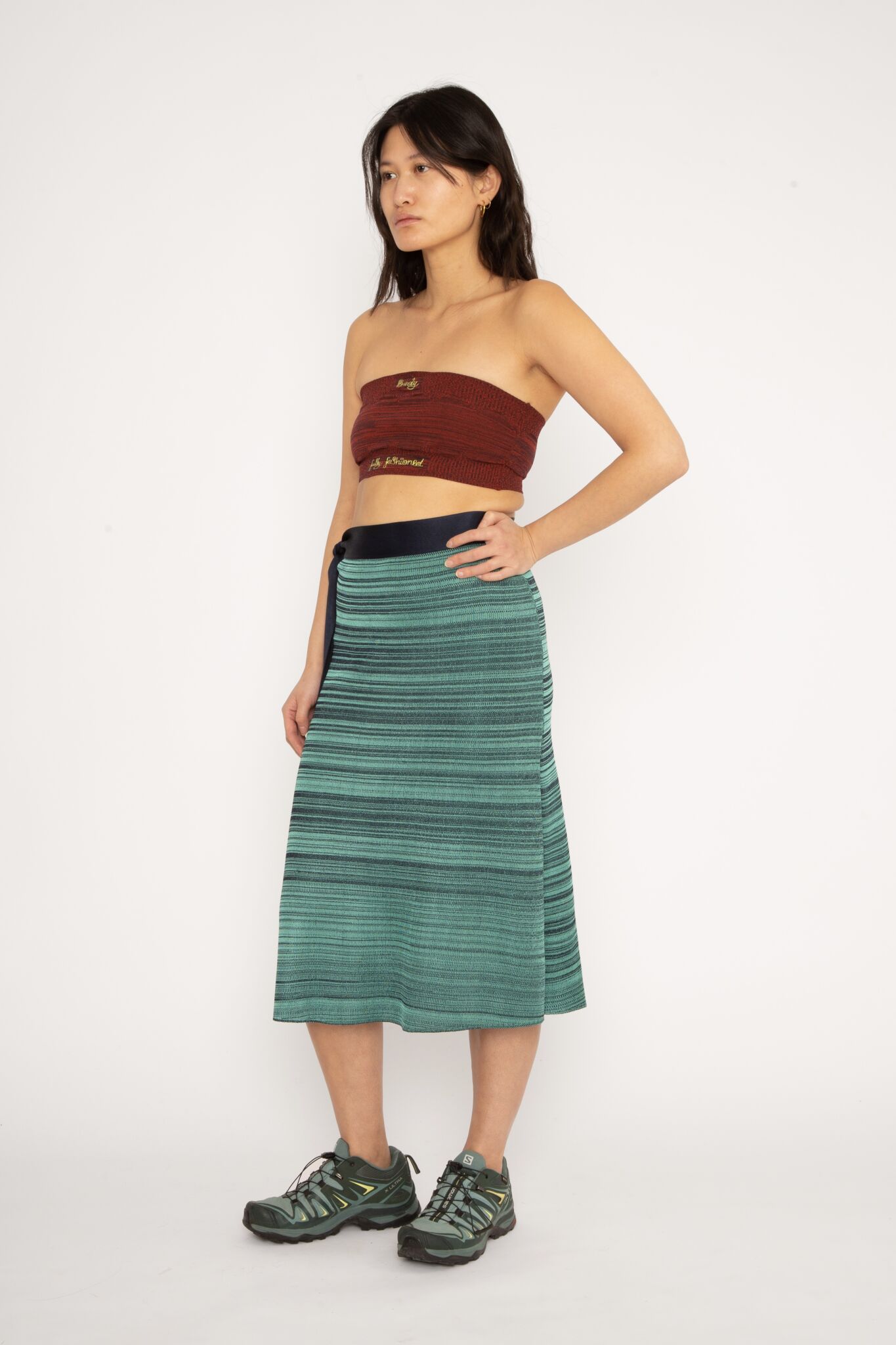 Melange Skirt in navy and teal is a knitted melange slip skirt with long ties to adjust the fit with. The textile has a shine to it and is lightweight with a smooth and soft feel against the body. The skirt is slightly stretchy and very comfortable to wear. The Melange Skirt is available in 3 different sizes.